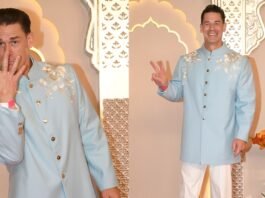 John Cena dancing at Anant Ambani and Radhika Merchant's wedding in traditional Indian attire.