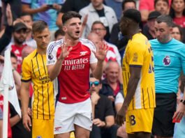 "Declan Rice shown a controversial red card during Arsenal vs. Brighton, sparking fan outrage.